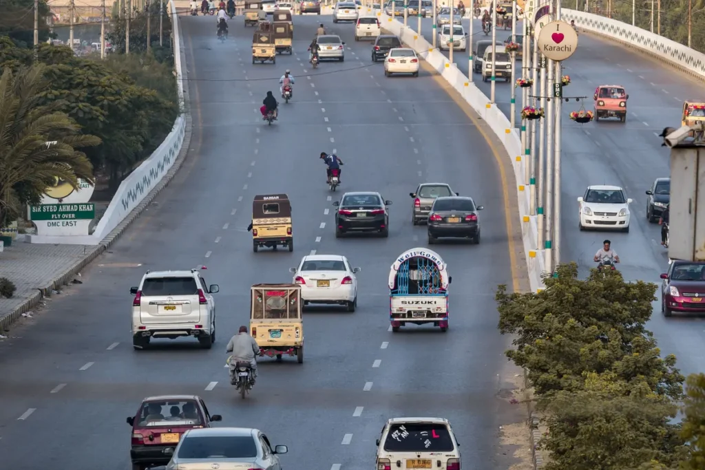Cars and motorcycles on an elevated road in Karachi, Pakistan.
