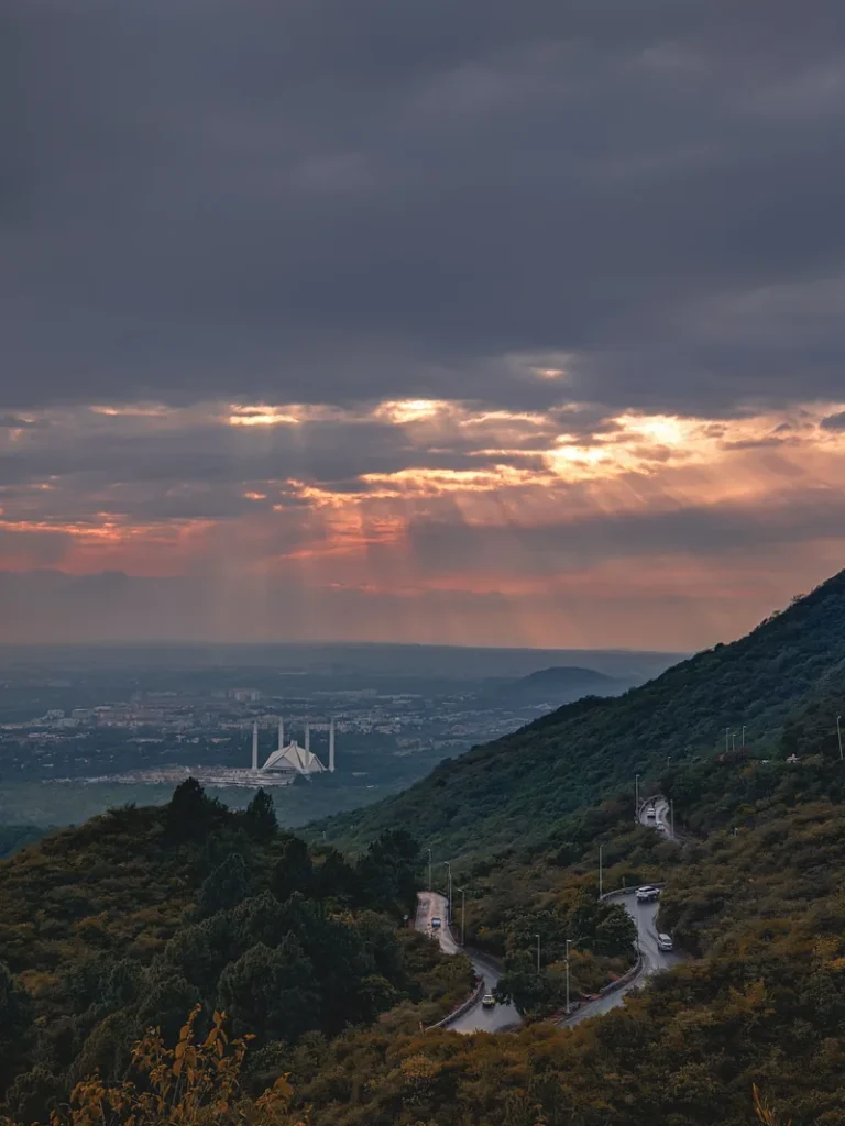 Faisal Mosque and Islamabad below the Margalla Hills at sunset.