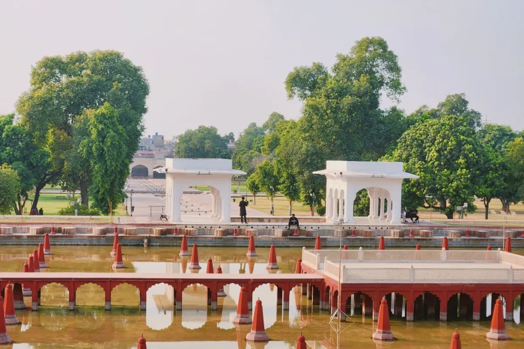 A water basin with rows of fountains and white marble pavilions at Shalimar Gardens in Lahore, Pakistan.