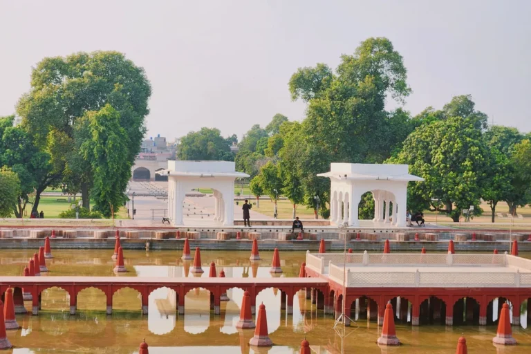 A water basin with rows of fountains and white marble pavilions at Shalimar Gardens in Lahore, Pakistan.